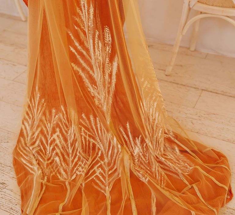 Orange linen and patterned golden wedding veil 