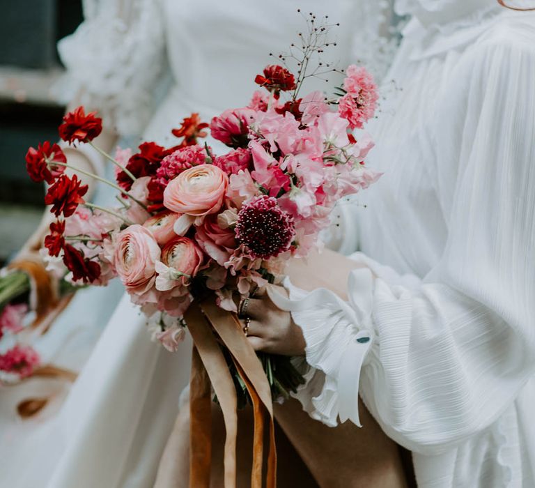 romantic pink and red wedding bouquet with sweet peas and butterfly ranunculus flowers 