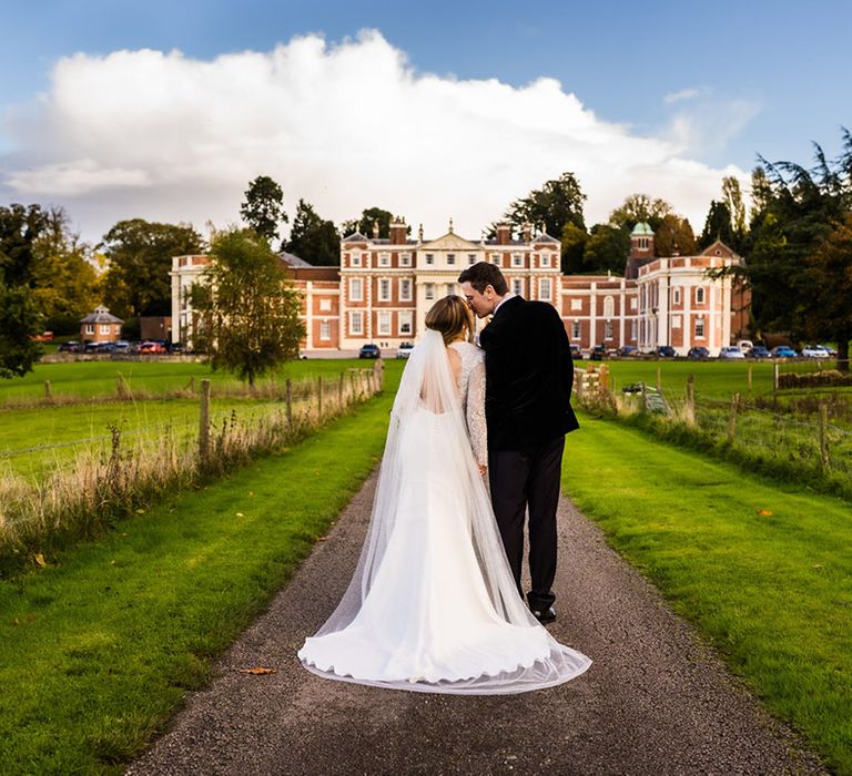 Bride and groom kiss in front of stunning Hawkstone Hall wedding venue