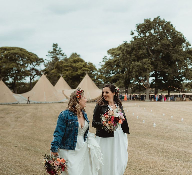 Brides was together in their embroidered bridal cover ups for their fun festival wedding with camping and a tipi