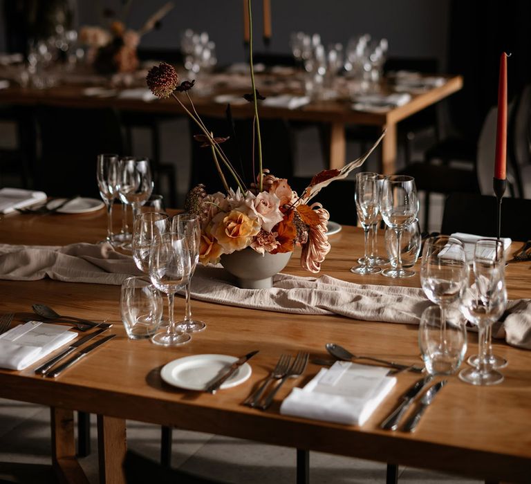 Japanese styling of flowers for the table centrepieces with neutral colour flowers and dried grass 