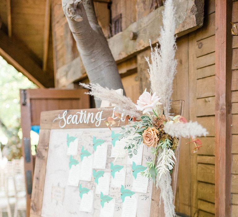 Wooden wedding signage complete with dried floral decor at the Alnwick Garden Treehouse wedding venue