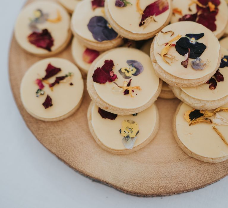 Flower pressed wedding biscuits on a wooden serving slate 