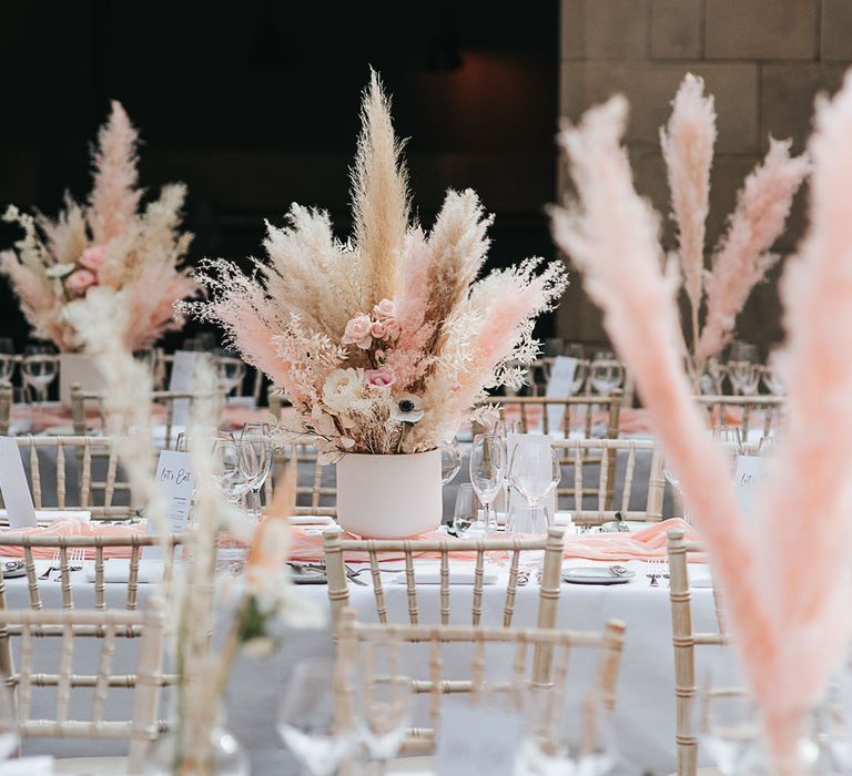 Modern and boho wedding reception with white and pink pampas centrepiece decor at Hampton Manor 