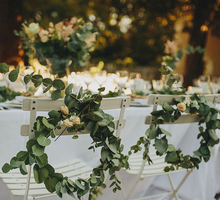 Round foliage arrangement wedding chair decor with yellow roses 