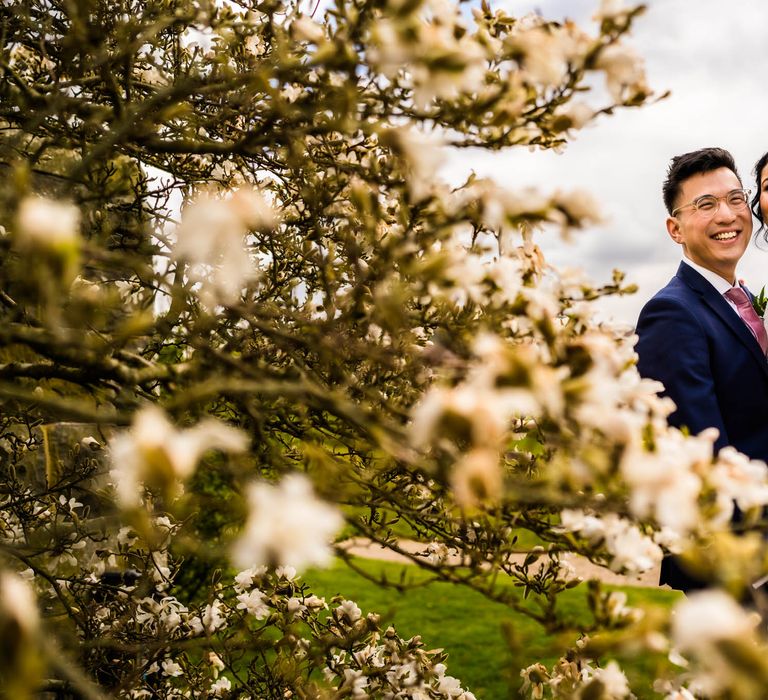 Bride & groom embrace outdoors for couples portraits 