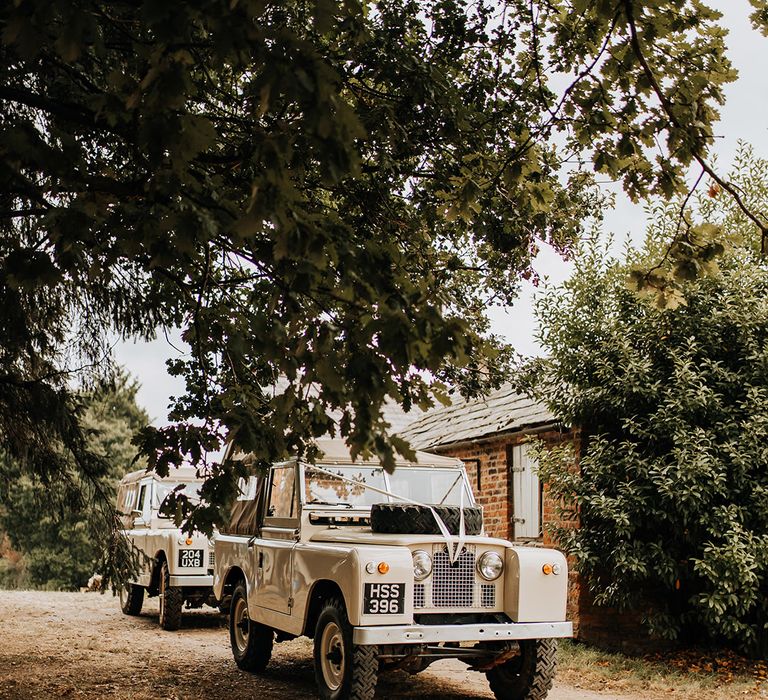 Cream wedding truck transport with the classic white ribbon decoration 