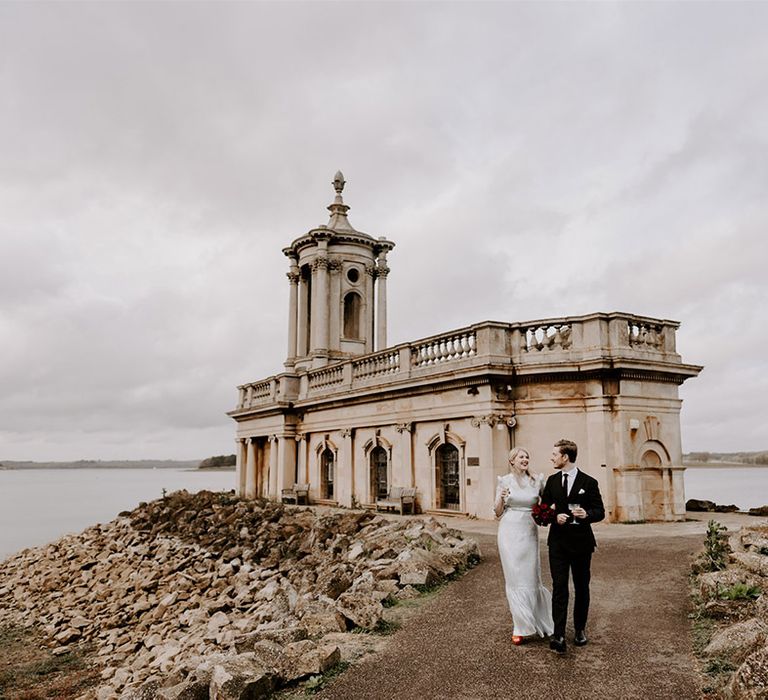 Normanton Church wedding with the bride and groom walking around the grounds together 