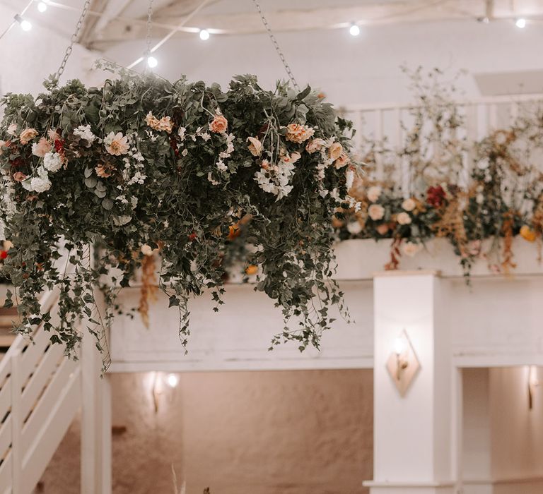 Cosy candlelit wedding venue, Wyresdale Park with hanging flower installation for autumn wedding 