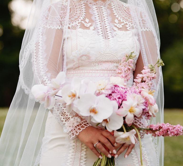 Bride in delicate long sleeve lace wedding dress by Temperley Bridal 