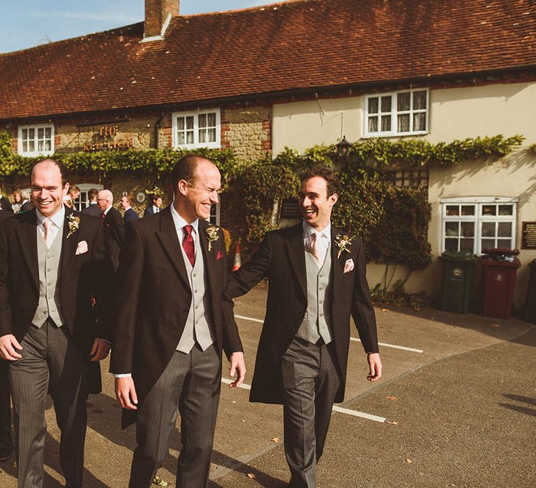 Groom and groomsmen at the wedding in morning suits 