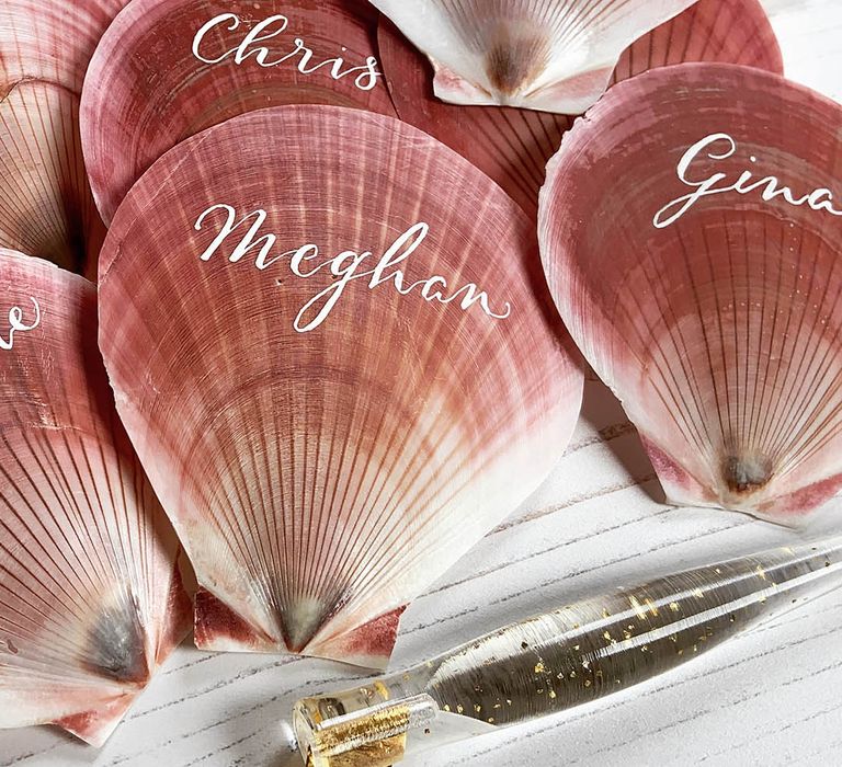 Pink shells for wedding tablescape with white calligraphy place name 