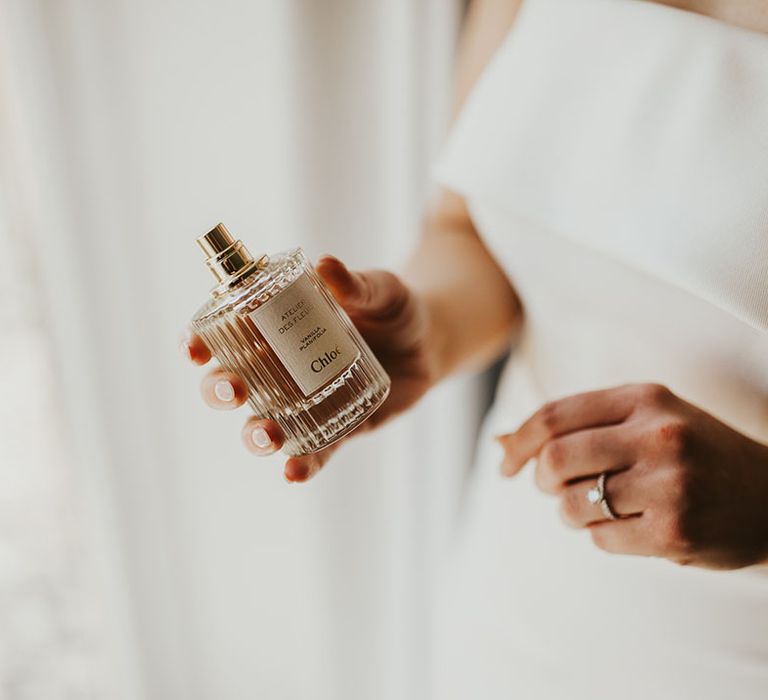 Bride putting on Chloe wedding perfume 