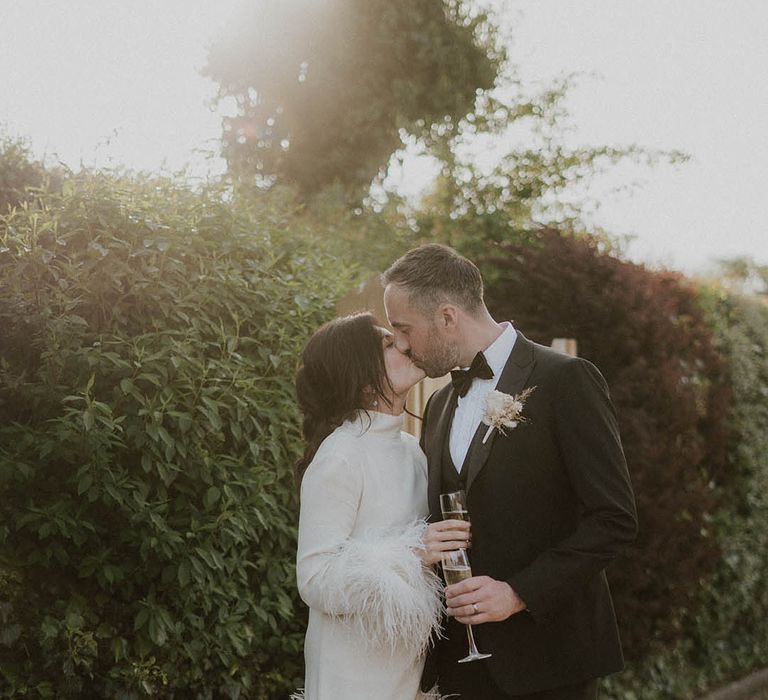 Larkspur Lodge wedding for modern contemporary wedding with bride wearing a short gown with feathers 