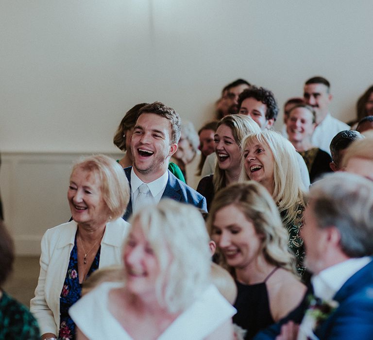 Wedding guests chuckle at the funny and personal wedding ceremony for LGBTQI+ couple 