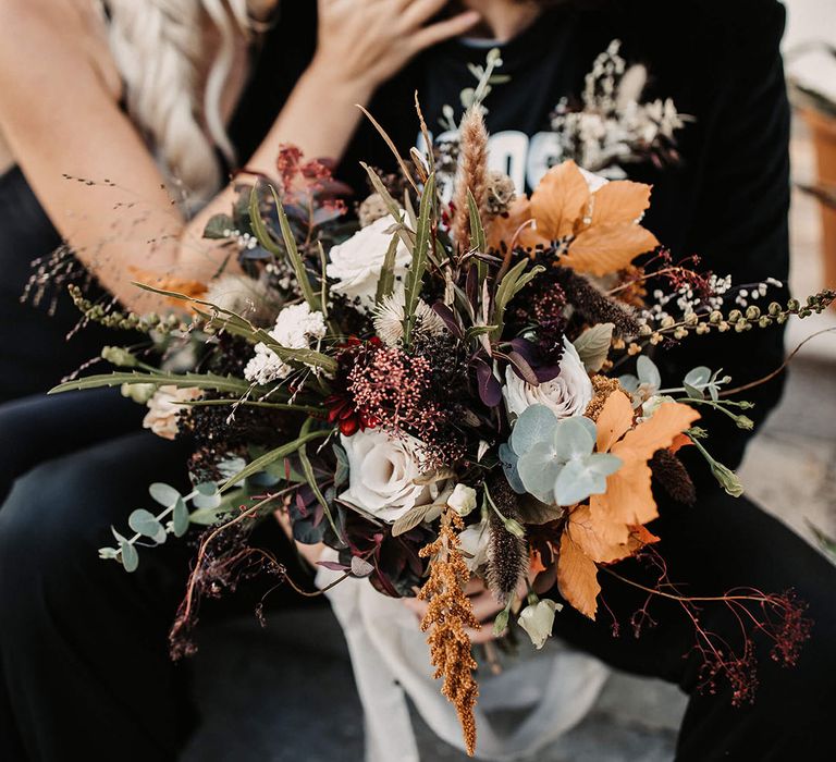 Halloween theme wedding with moody autumnal flower bouquet for the bride 