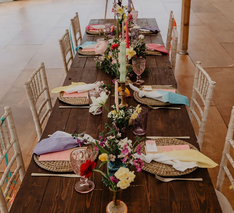 Minimalist wedding tablescape with pops of colour from the napkins at boho festival wedding 