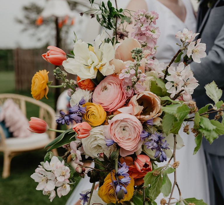 Pink and yellow oversized wedding bouquet with tulips, peonies, bell flowers and more 