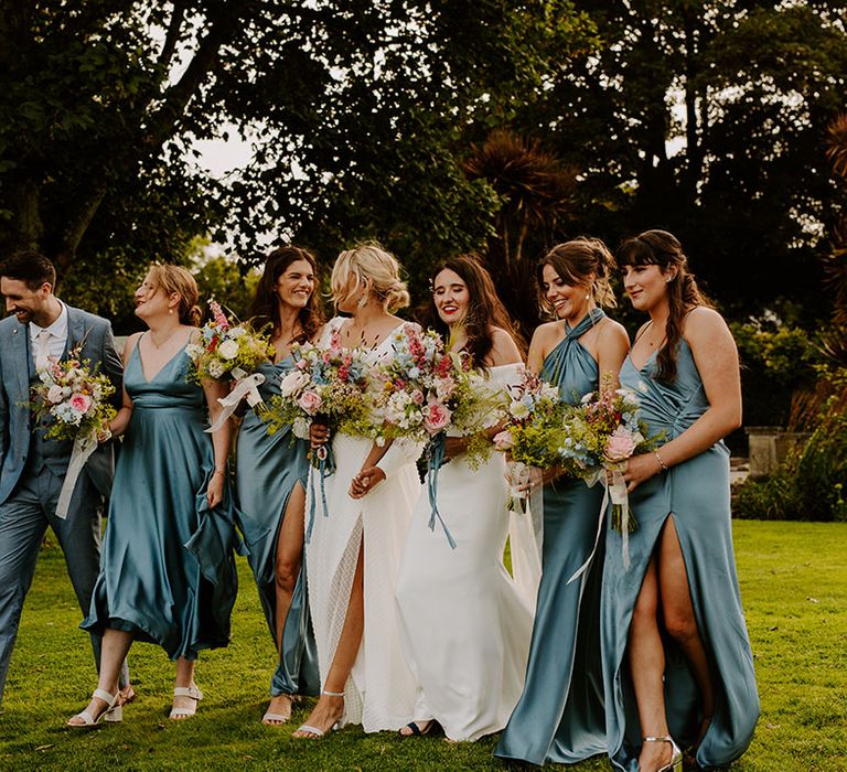 Mixed gender wedding party with bridesmaids and bridesmain in blue wedding outfits 