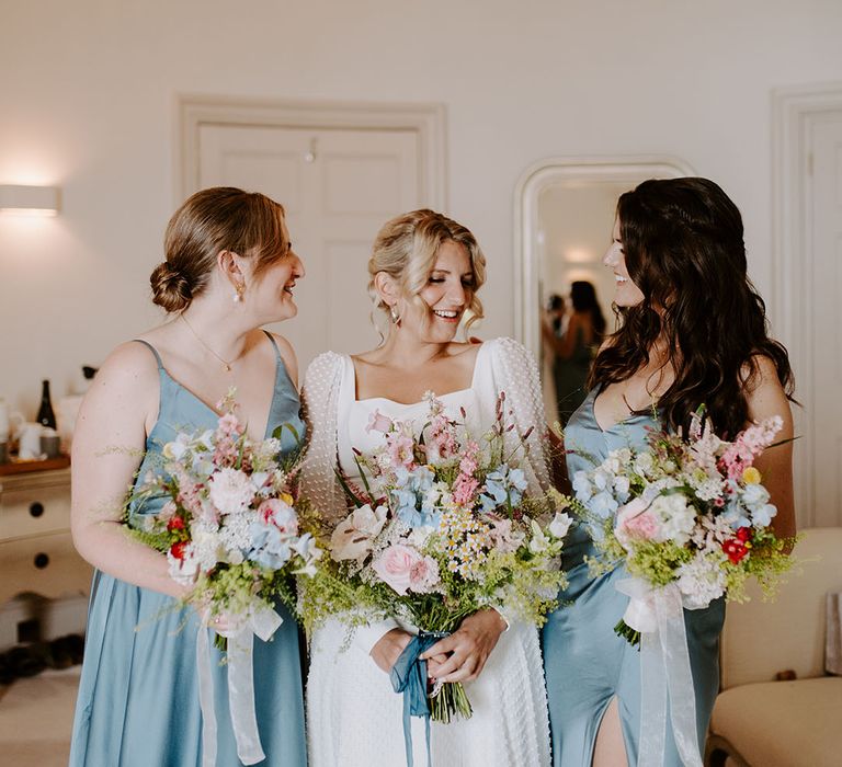 Bridesmaids in blue bridesmaid dresses for whimsical coastal theme wedding in Dorset 