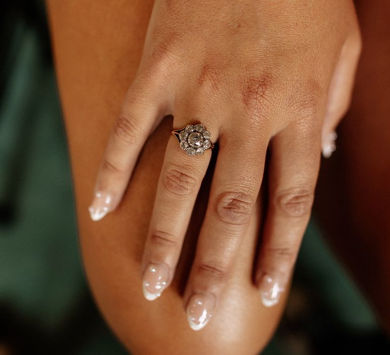 Bride wearing a floral diamond vintage engagement ring with pearl wedding nails 