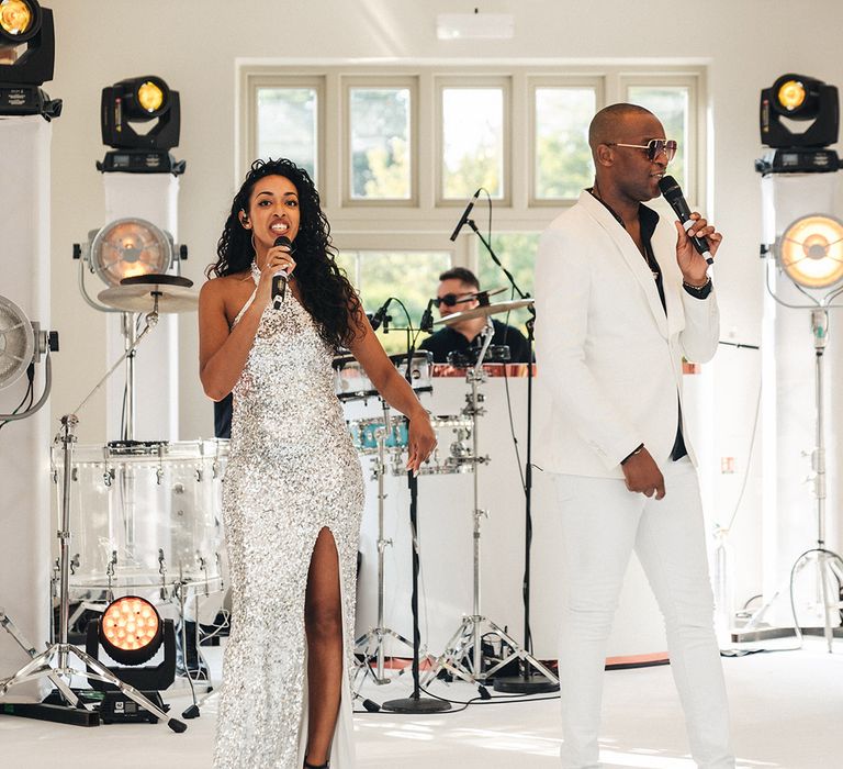 Wedding singers in white outfits perform at the wedding breakfast 