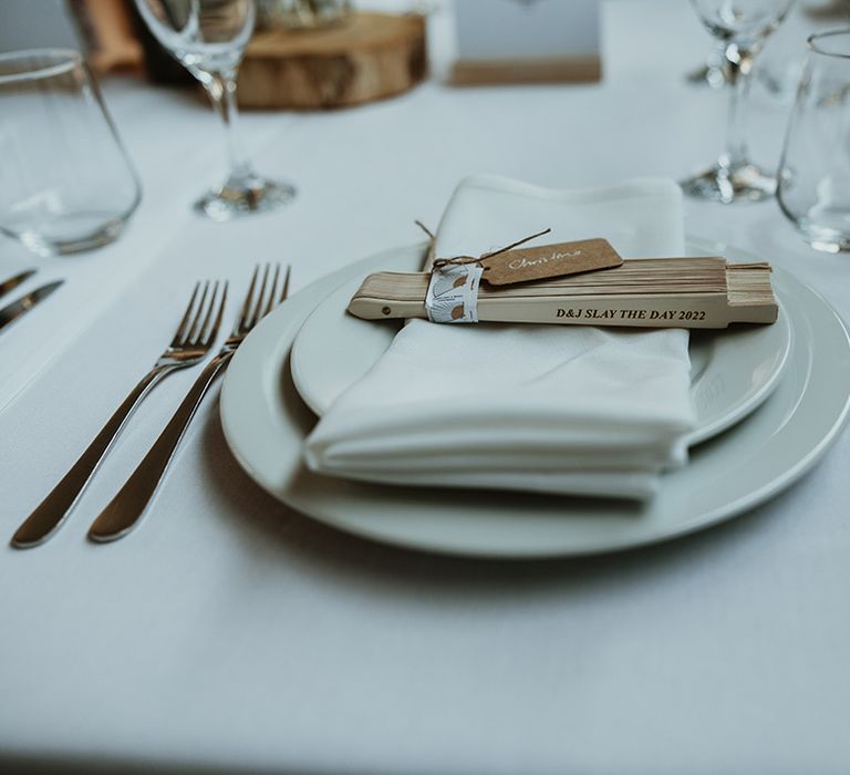 Minimalist white wedding tablescape with wedding fan favours for rustic wedding 