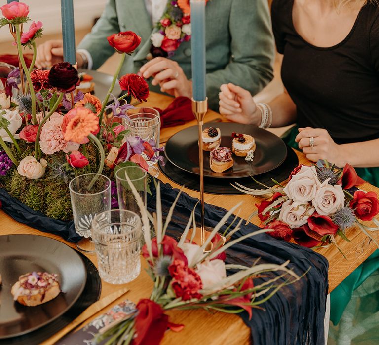 Blue wedding candles and colourful wedding flowers decorate the tablescape for the intimate elopement wedding 