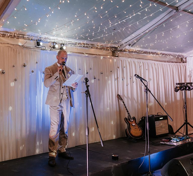 Groom reads out wedding speech at marquee wedding 