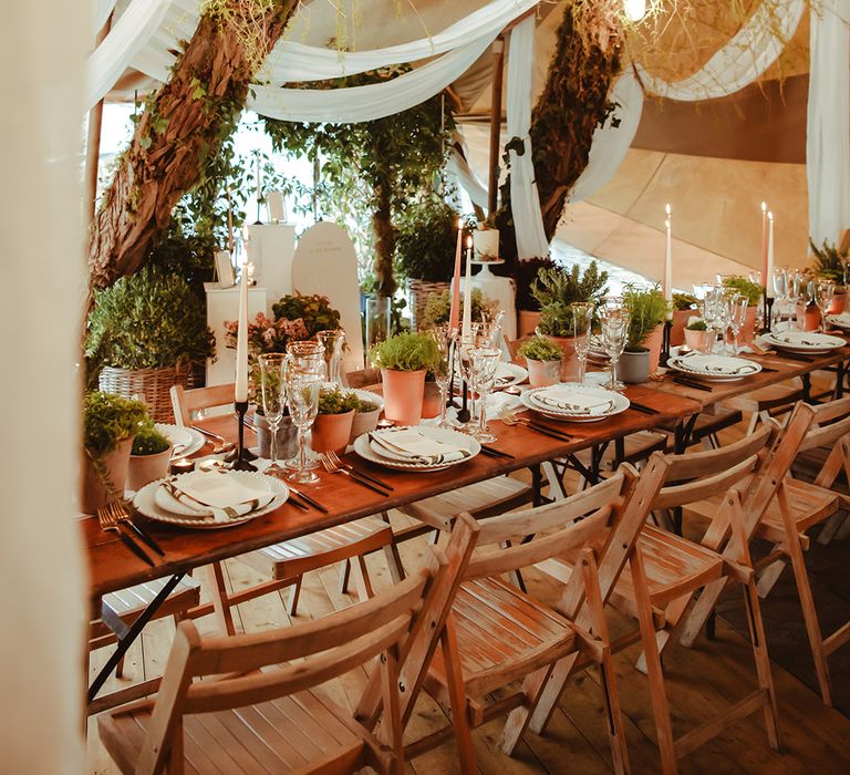 Eco-friendly sustainable wedding decor with drapery including peach and grey taper candles for the table decorations 