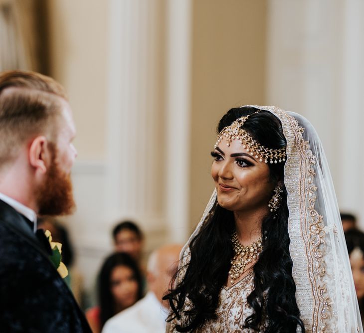 Indian bride in Ivory and Gold embellished dress and veil