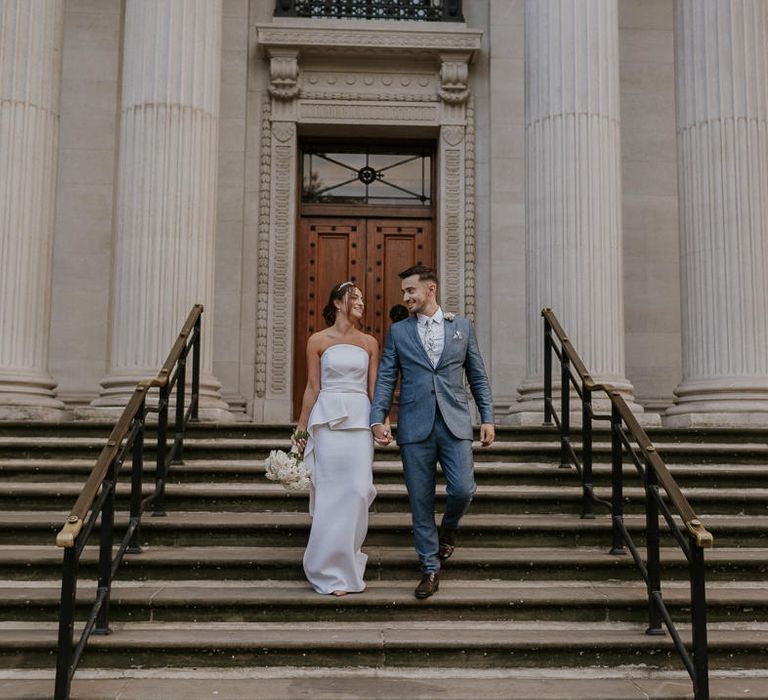 Bride and groom on the steps at Old Marylebone Town Hall 