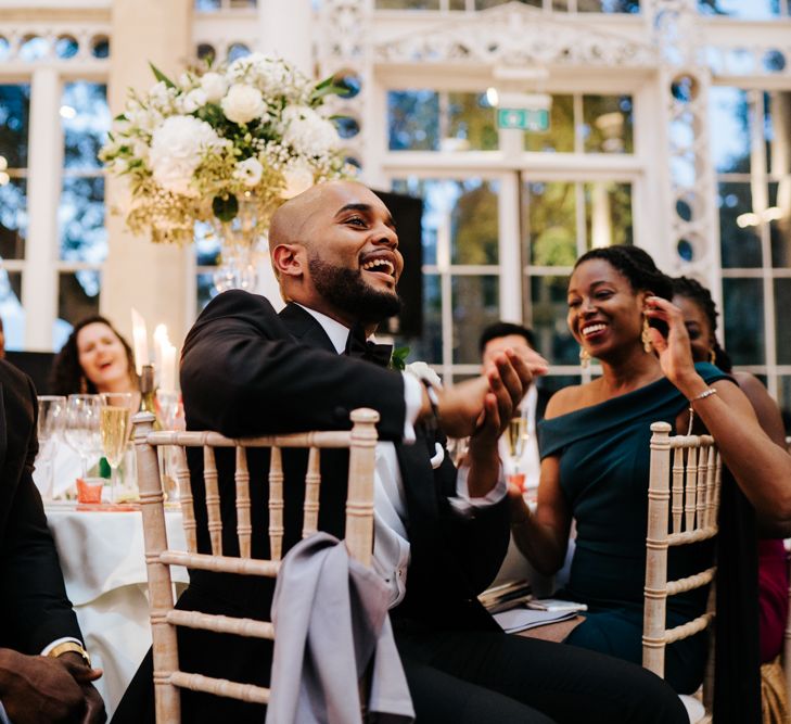 Wedding guests laughing during the reception 