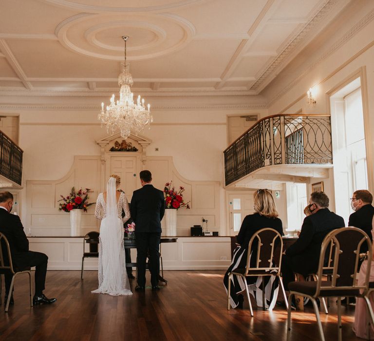 Bride and groom exchanging vows at Poole registry office civil wedding ceremony 