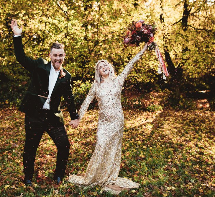 Bride and groom celebrating in woodland setting. Photography by Maryanne Weddings.