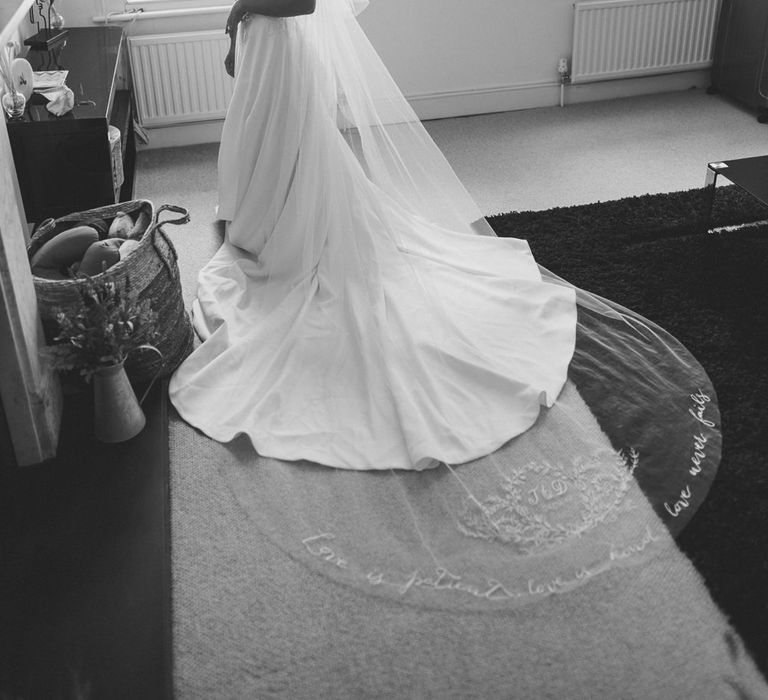 Bride on the wedding morning putting on her personalised veil 