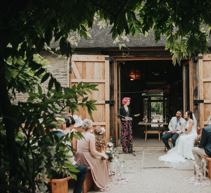 Celebrant talks to couple at wedding cermony