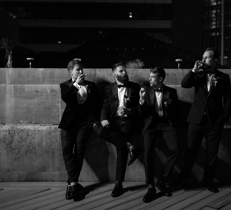 Groomsmen smoking cigars at Manchester wedding 