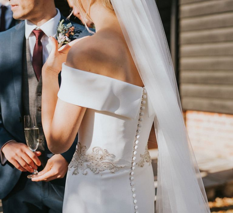 Bride wears buttoned down wedding dress 