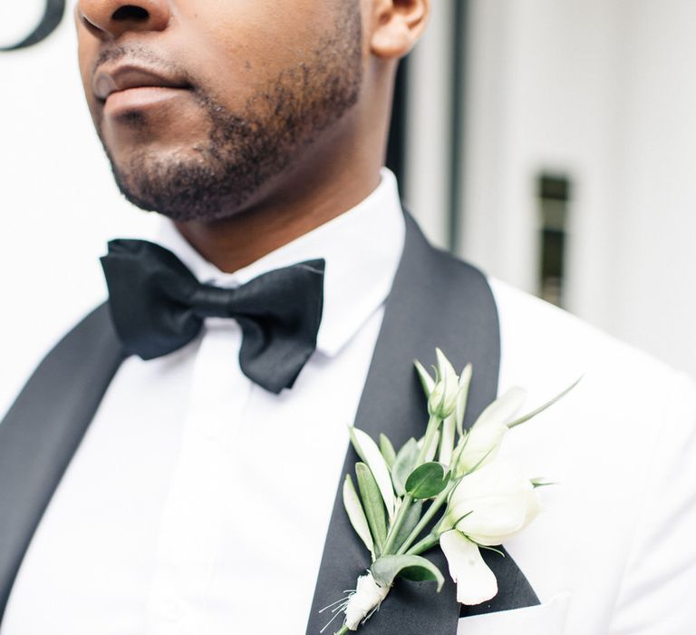 Grooms monochrome tux with white floral buttonhole