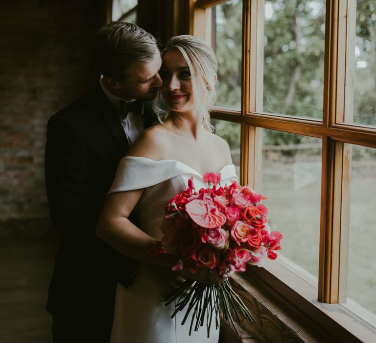 Bride & groom look out the window