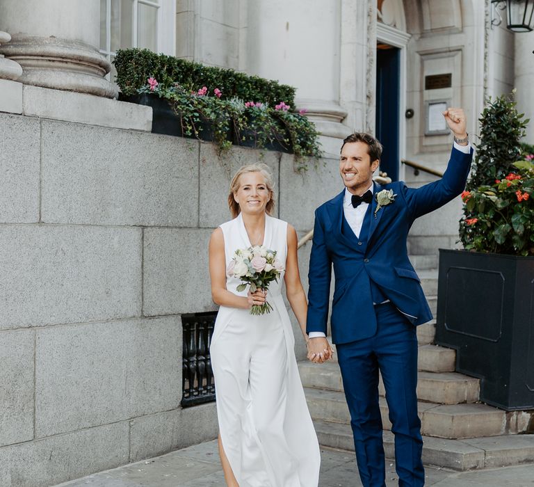 Bride & groom walk through London after wedding ceremony