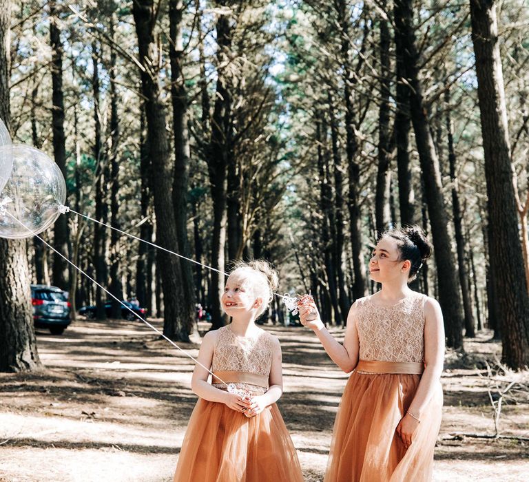 Flower girls in tulle dresses with balloons