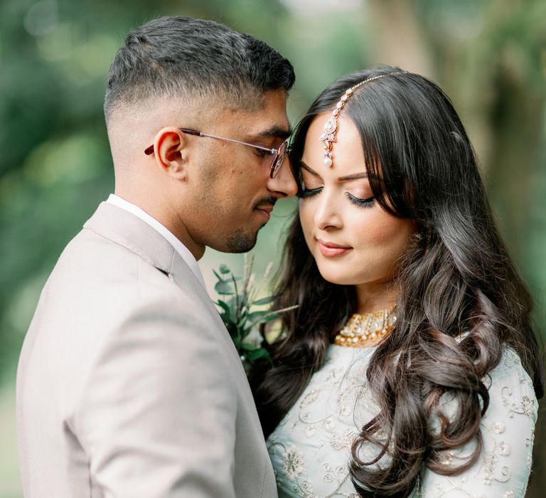 Beautiful Muslim bride in a mint green and white embroidered sari with headdress 