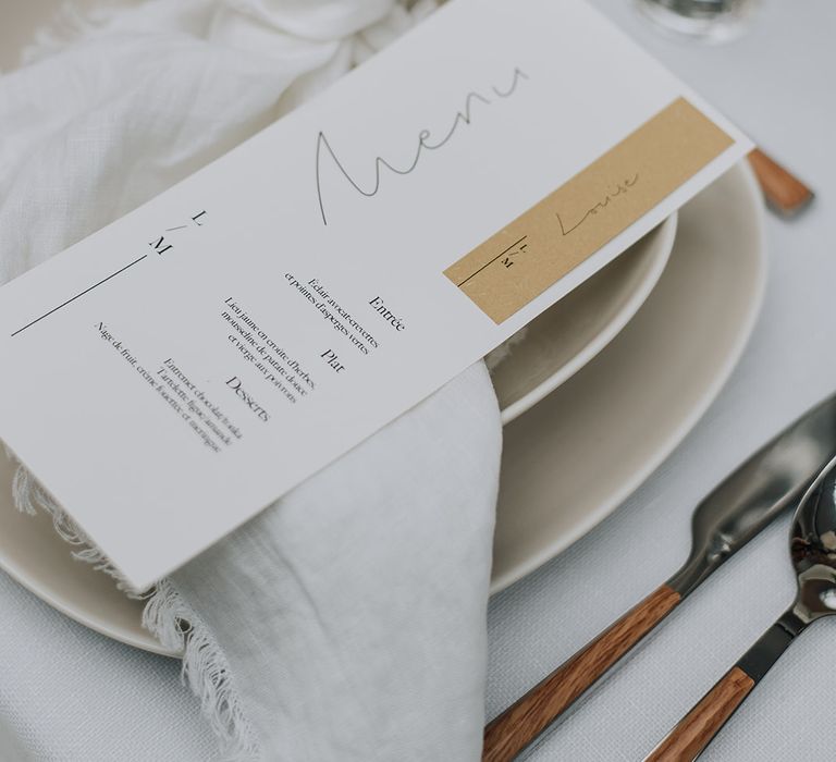 White wedding menu with frayed edge linen napkins and neutral tableware