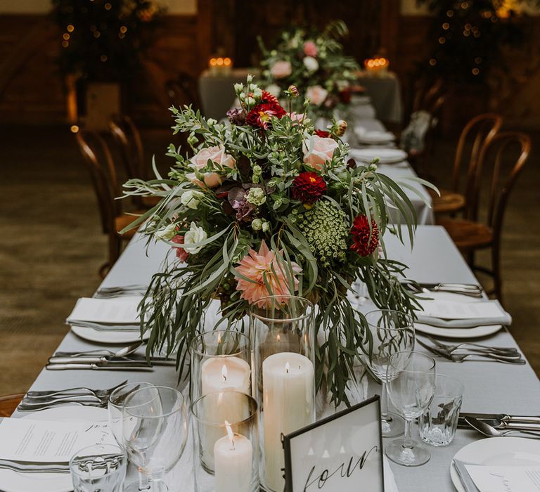 Natural wedding flowers table centrepieces with foliage and pink and red roses 