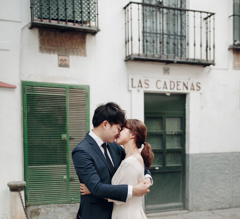 Asian couple kiss on street in Seville