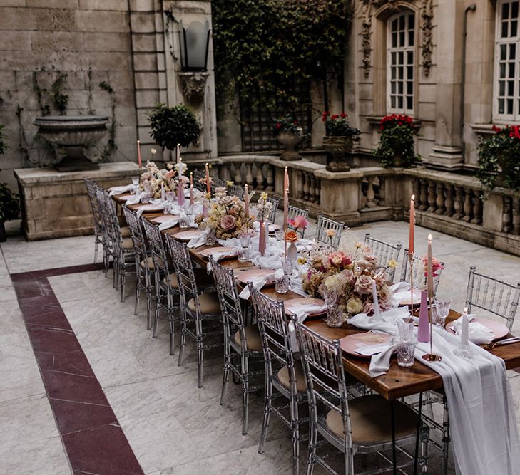 Outdoor wedding tablescape at Dartmouth Weddings venue in Mayfair with pink flowers and taper candles 