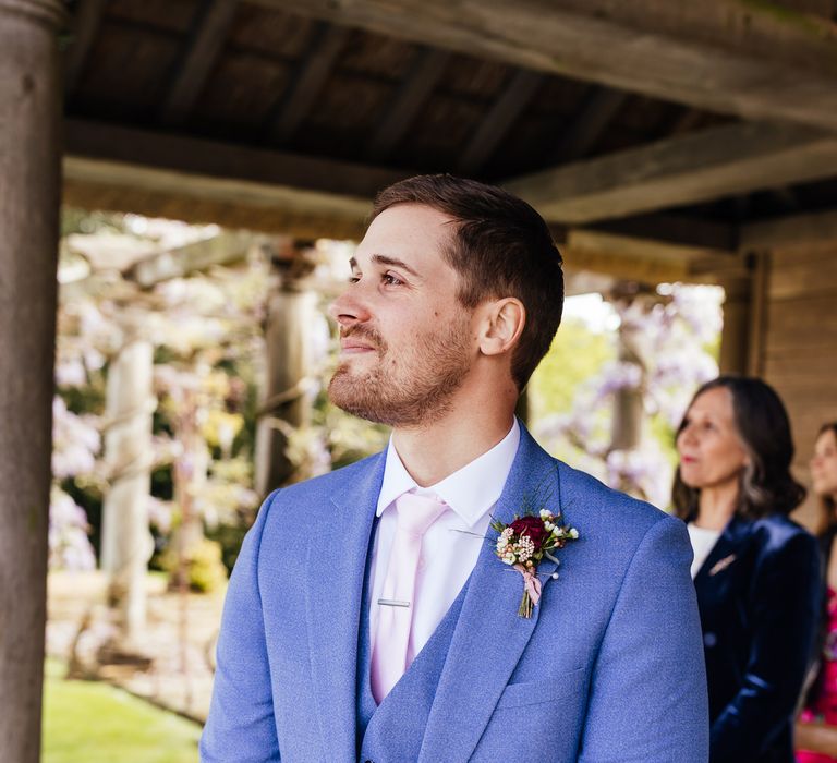 Groom wears pale blue suit on wedding day