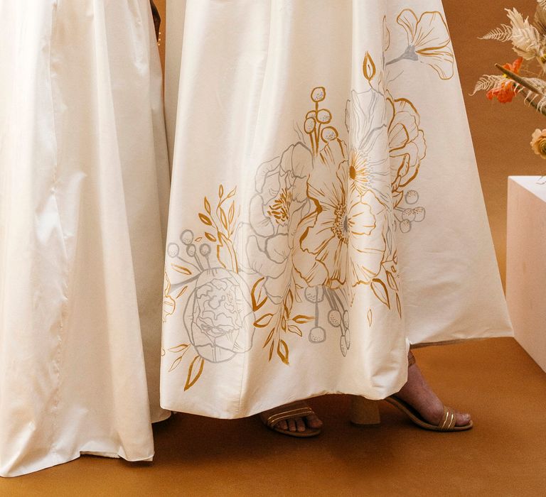 Customised hand painted gold and silver floral illustrations on wedding skirts by Bee Davies